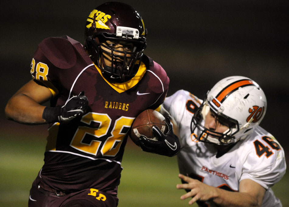 East Peoria's Michael Thompson (28) breaks away from Washington's Dan Massengill  (46) during a game on Friday, Sept. 10, 2010, in East Peoria.