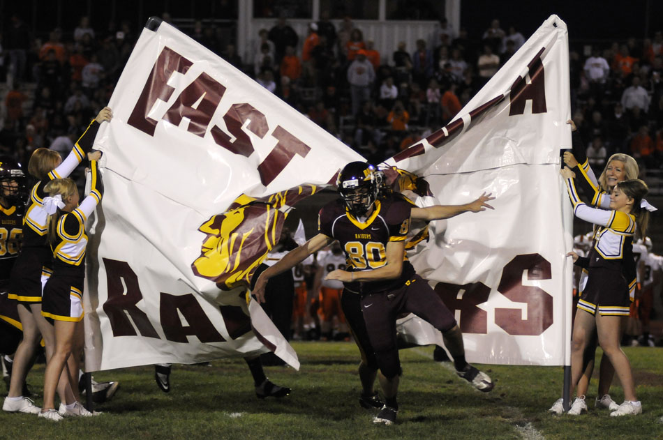 East Peoria's Brennen Kinsman (80) leads the team through the school banner prior to a game against Washington on Friday, Sept. 10, 2010, in East Peoria.
