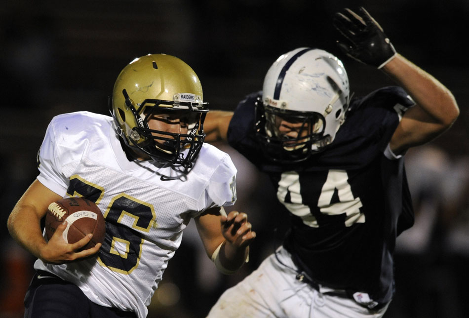 Quincy Notre Dame's Zak Thompson (26) breaks away from Peoria Notre Dame's Patrick Doyle (44) during a game on Thursday, Sept. 16, 2010, in Peoria.