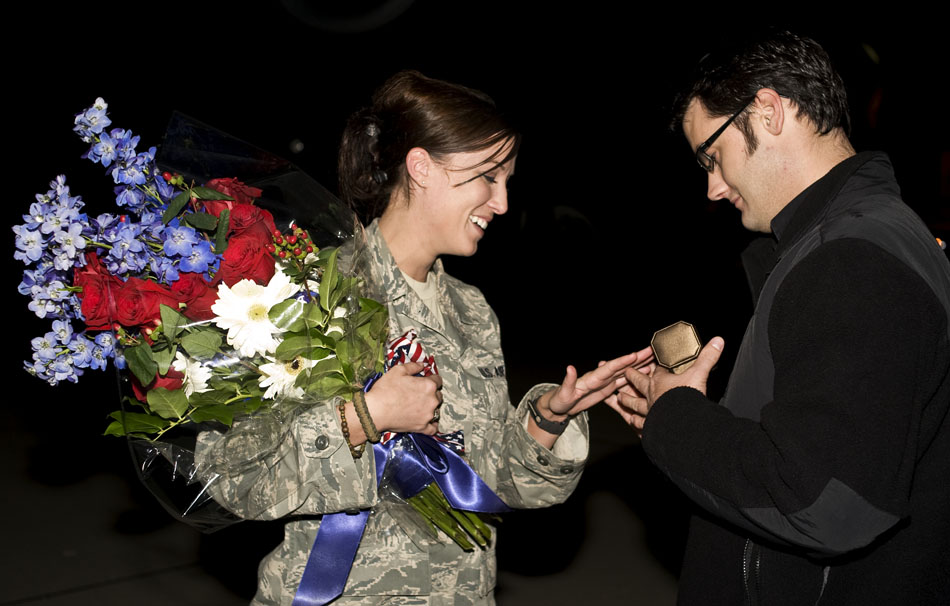 Proposal Brock Menold, right, slips a diamond ring on Sgt. Heather Richards' finger after Menold proposed to his girlfriend of three years on the tarmac on Monday, Sept. 27, 2010, at the Illinois Air National Guard base in Peoria. Richards, who said yes, just returned from a three month deployment in Afghanistan.