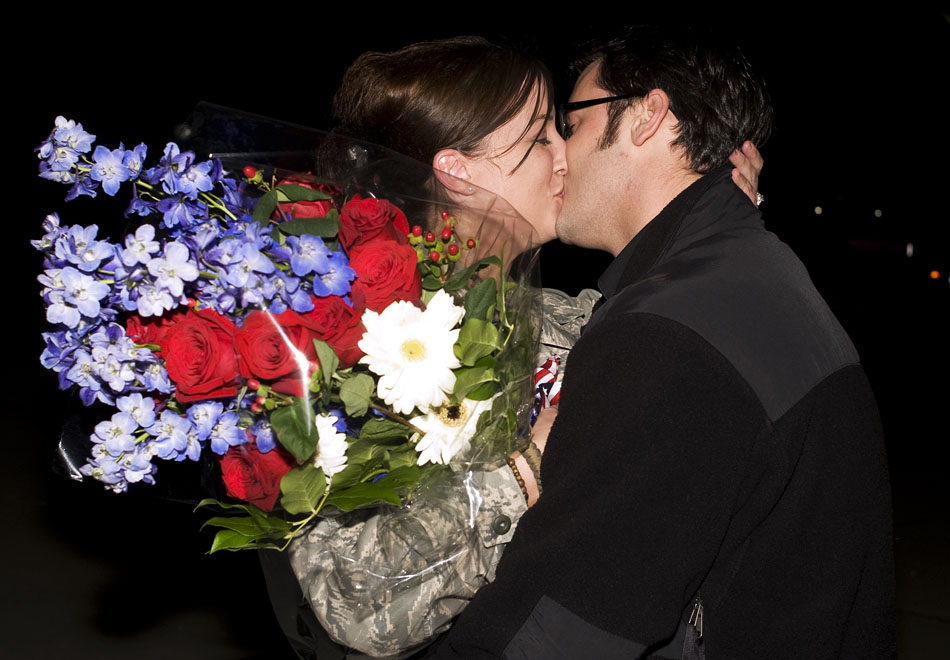 Brock Menold, right, kisses Sgt. Heather Richards after Menold proposed to his girlfriend of three years on the tarmac on Monday, Sept. 27, 2010, at the Illinois Air National Guard base in Peoria. Richards, who said yes, just returned from a three month deployment in Afghanistan.