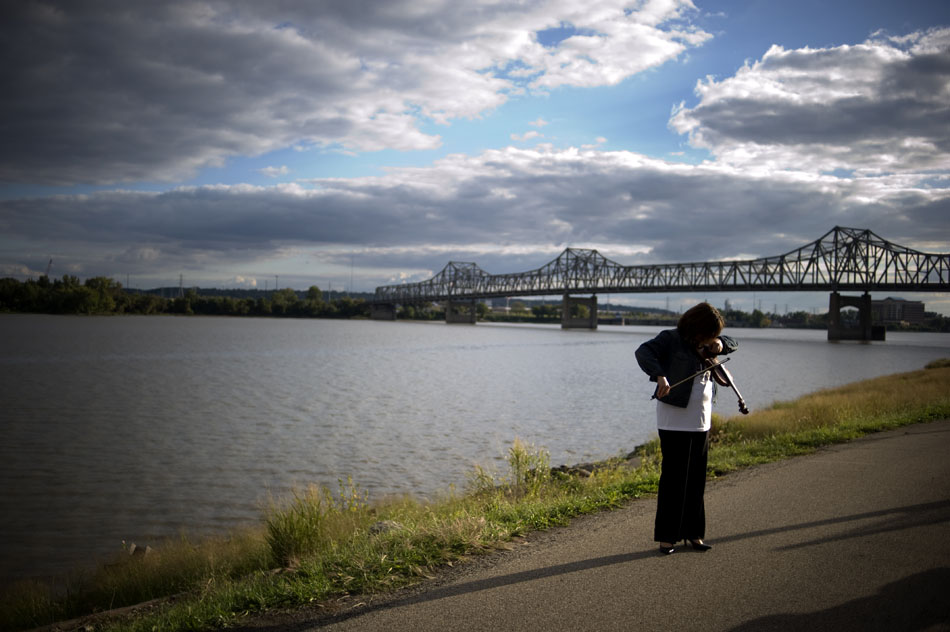 Jodi Smith plucks a few notes on her violin as she prepares to play in a remembrance walk during the National Day of Remembrance on Sunday, Sept. 26, 2010, at the RiverPlex. The day is for grieving families and friends of people who were killed through violence.