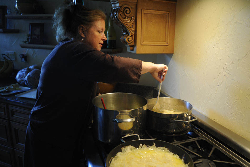 Ladona Fishkin stirs a pot of homemade apple sauce as she cooks foods to be served at a Thursday evening Rosh Hashanah dinner on Wednesday, Sept. 8, 2010, at her Peoria home. Apples are a common symbolic food served at Rosh Hashanah because its sweetness is thought to help usher in a sweet new year.