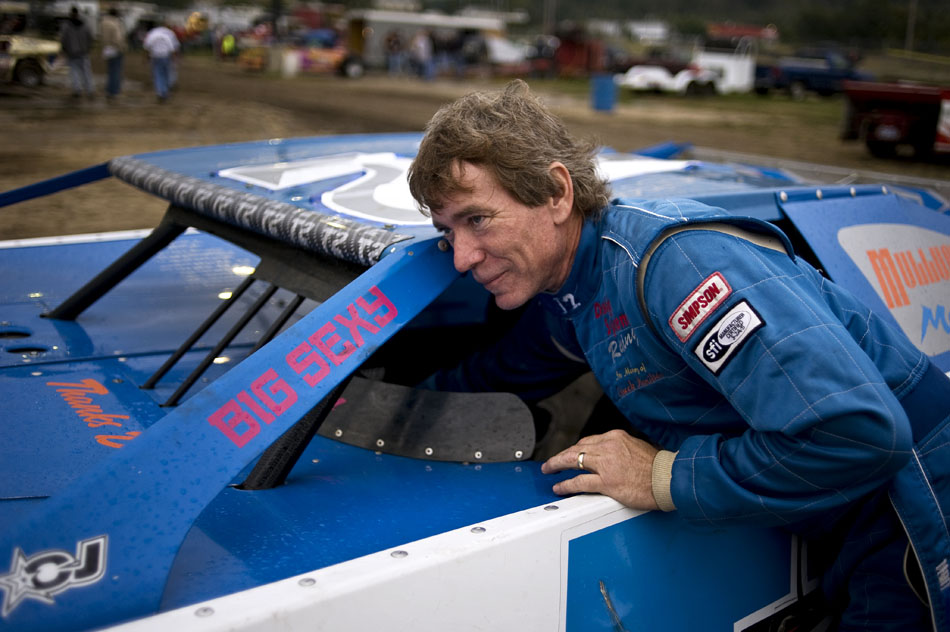 Todd Bennett reaches inside his race car before hopping in to take a few laps around the track on Saturday, Sept. 18, 2010, at Peoria Speedway.