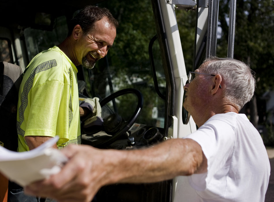 West Peoria garbage collector Jeff Reagan, left, shares a laugh with local customer Ron Eckstein as Reagan works his shift on Thursday, Sept. 23, 2010. "He's probably the best garbage man we've ever had," Eckstein said of Reagan. "Don't tell him that"