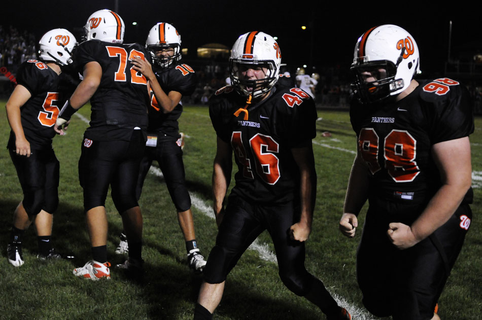 Washington's Dylan Koonce (98) and Dan Massengill celebrate after the team recovered a fumble deep in Dunlap territory during a game on Friday, Sept. 17, 2010, in Washington.