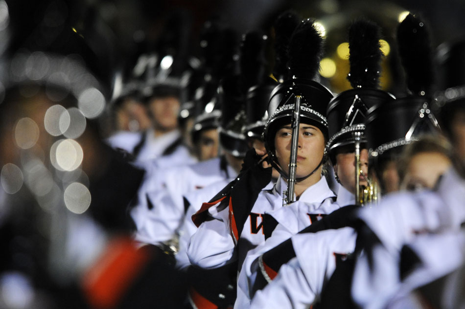 A member of the Washington marching band straightens up before a performance at halftime in a game against Dunlap on Friday, Sept. 17, 2010, in Washington. The band played a selection of music from the rock band Journey.