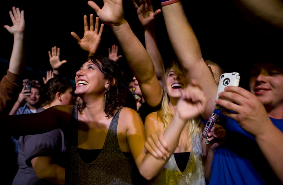 Fans react after Weezer frontman Rivers Cuomo jumped off stage and hoped onto a barricade in front of the crowd while singing "Troublemaker" during a performance on Saturday, Sept. 25, 2010, at Bradley University.