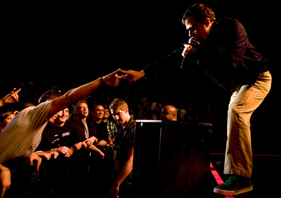 Weezer's Rivers Cuomo reaches out to touch a fan during a performance on Saturday, Sept. 25, 2010, at Bradley University.