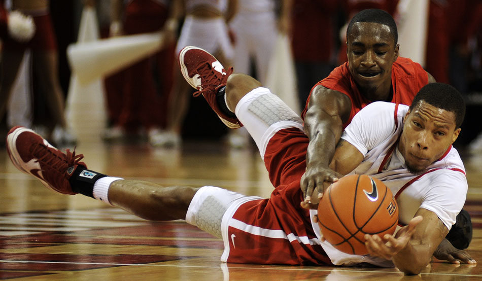 Bradley's Dyricus Simms-Edwards tries to flip the ball to a teammate as Charonn Woods wrestles for the ball during the red and white scrimmage on Sunday, Oct. 24, 2010, at the Renaissance Coliseum.