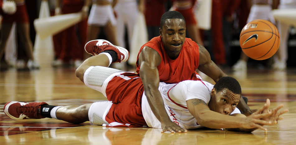 Bradley's Dyricus Simms-Edwards, bottom, flips the ball to a teammate as Charonn Woods wrestles for the ball during the red and white scrimmage on Sunday, Oct. 24, 2010, at the Renaissance Coliseum.
