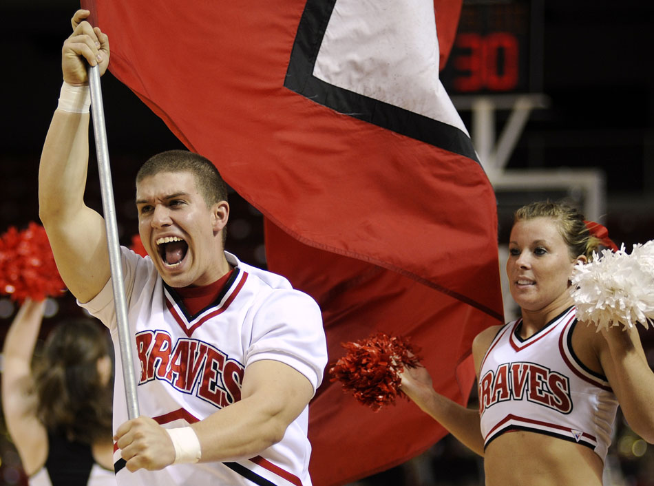 A Bradley cheerleader runs a flag with a letter "B" onto the court before the women's basketball scrimmage on Sunday, Oct. 24, 2010, at Renaissance Coliseum.
