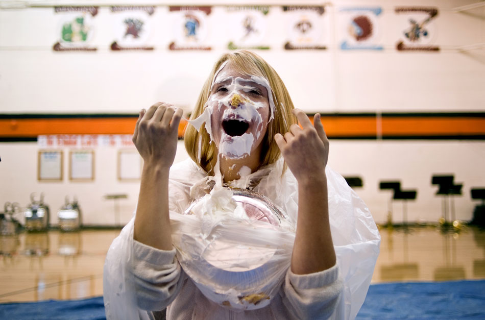 Sydney Houzenga, a sophomore at Elmwood High School, reacts after being pied in the face during an assembly announcing the results of the school's fundraising efforts for Easter Seals on Monday, Oct. 4, 2010, at the school.