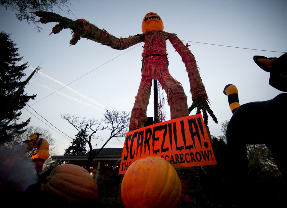Scarezilla, a 32-foot-tall scarecrow, looks over Fred Volkmar's front yard as trick-or-treaters make their rounds on Sunday, Oct. 31, 2010, along Tripp Avenue. Volkmar created the scarecrow using a metal frame and a lift that holds the monster in place from the backside. A computer and sound system allowed him to talk to youngsters in a voice similar to that of Optimus Prime from the movie "Transformers."