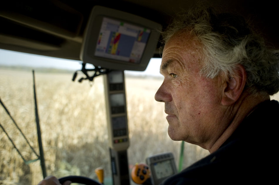 Mike Schachtrup watches out the windshield as he combines a field of corn on Monday, Oct. 11, 2010, near the intersection of Alta Lane and  Radnor Road. Schachtrup farms about 6,000 acres in Peoria, Tazewell, Knox and Warren counties with his brothers including this 70-acre field northwest of Peoria.