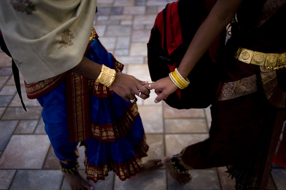 Two members of the Shree Ramana Maharishi Academy for the Blind in India hold hands as they are lead onto the stage before a performance on Sunday, Oct. 17, 2010, at the Hindu Temple of Central Illinois.