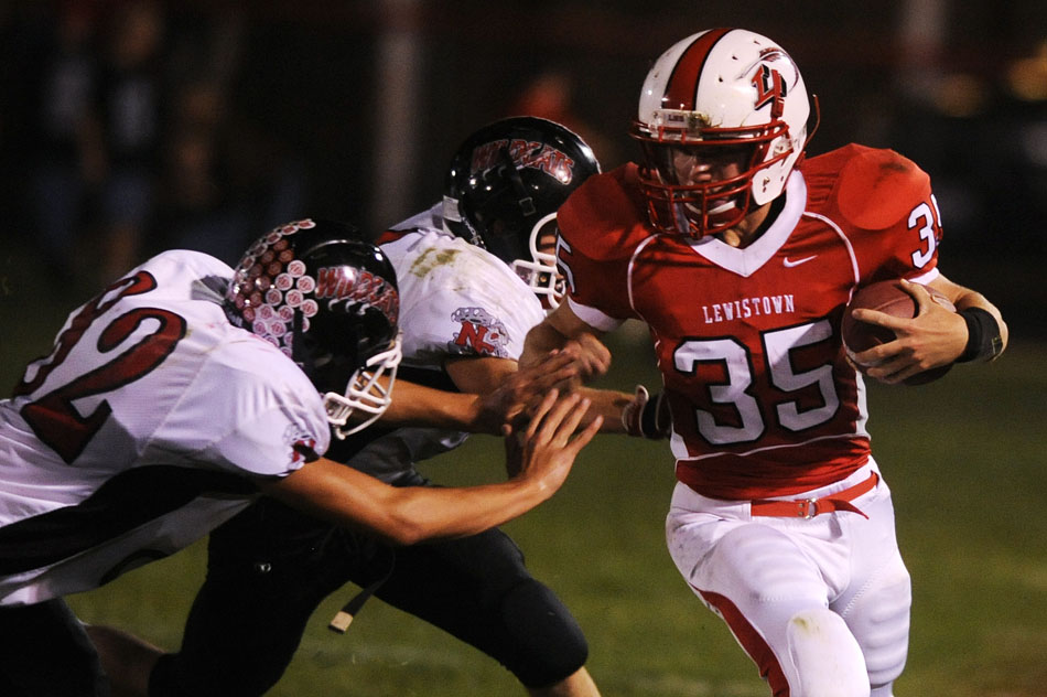 Lewistown's Austin Howerter looks to turn the corner against North Fulton defenders during a game on Friday, Oct. 8, 2010, in Lewistown.