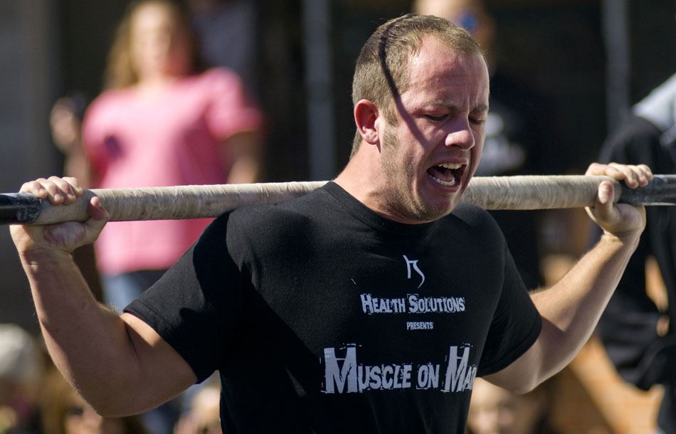 Kristopher McCauley struggles as he carries a rig with two weighted refrigerators weighing in at 625 pounds 80 feet down Main Street in Morton, Ill. on Saturday, Oct. 2, 2010, during Muscles on Main.