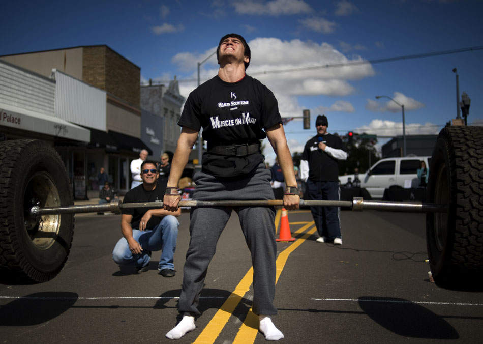 JAMES BROSHER/Journal Star Ben Sanchez, of Kokomo, Ind., lifts two rims and tires from a Hummer weighing  in at 425 pounds during Muscles on Main on Saturday, Oct. 2, 2010, in Morton, Ill.