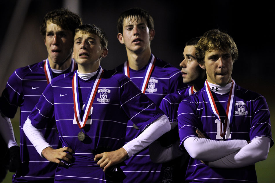Peoria Christian's Jonathan Hartman (12) and Dylan Schwartz (10) react after receiving their second-place medals after the Class 1A state championship on Saturday, Oct. 30, 2010, in Naperville. Lisle won 1-0 for the title.