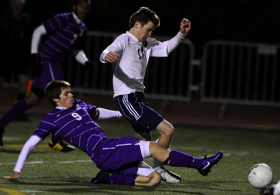 Peoria Christian's Jonathan Lehman (9) slides to kick the ball away from Lisle's Jacob Soukup during the Class 1A state championship on Saturday, Oct. 30, 2010, in Naperville. Lisle won 1-0.