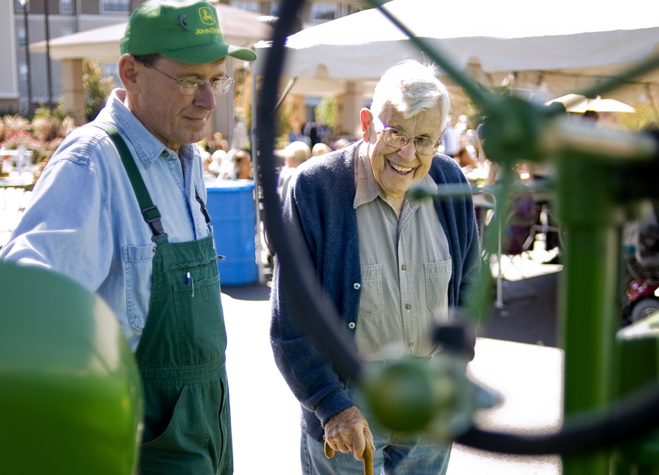 Terry Kellstedt, right, smiles as he looks over a 1941 John Deere Model B tractor owned by Terry Beachler, left, during an event on Thursday, Oct. 7, 2010, at the Lutheran Hillside Village.