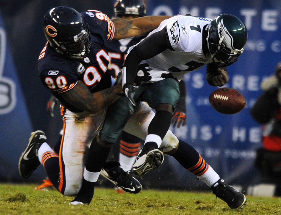 Philadelphia Eagles quarterback Michael Vick (7) fumbles the ball as he's sacked by Chicago Bears defensive end Julius Peppers (90) during the first half of a game on Sunday, Nov. 28, 2010, at Soldier Field in Chicago.