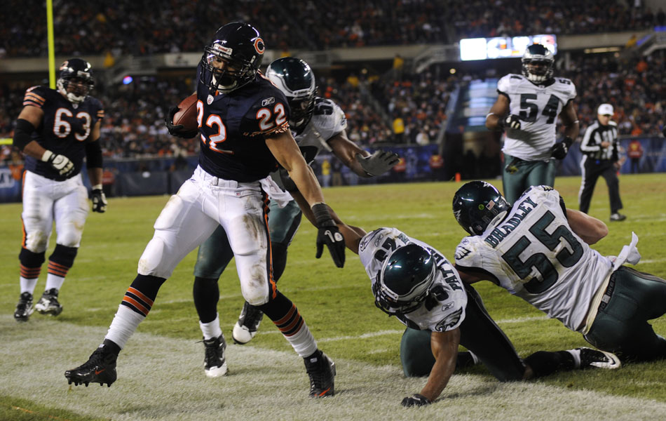 Philadelphia Eagles cornerback Dimitri Patterson (23) and linebacker Stewart Bradley (55) force Chicago Bears running back Matt Forte (22) out of bounds during a game on Sunday, Nov. 28, 2010, at Soldier Field in Chicago.