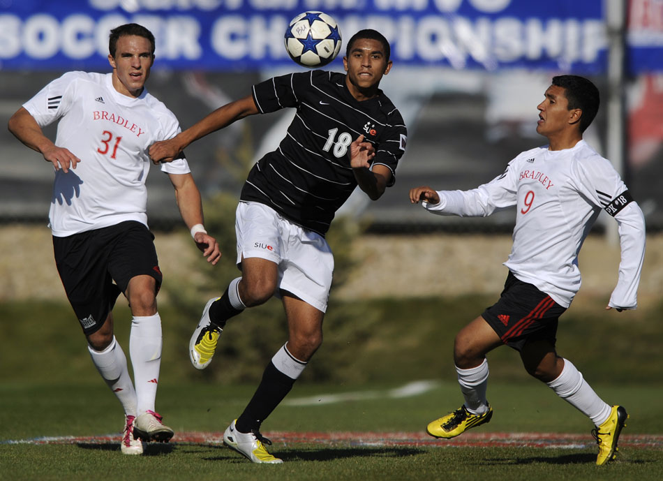 SIU Edwardsville's Jordan Barnes (18) plays the ball between Bradley defenders Mike Hnat (31) and Rudy Garcia (9) during a game on Sunday, Nov. 14, 2010, at Shea Stadium.