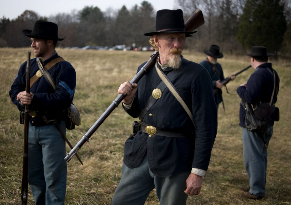 Tim Varvil, the president of the Central Illinois Living Historians, rests his rifle over his shoulder after a demonstration of Civil War military exercises for a group of bystanders on Saturday, Nov. 20, 2010, at Sommer Park. The re-enactors created a Civil War winter encampment to show how soldiers lived through the winter months when fighting generally stopped in the war.
