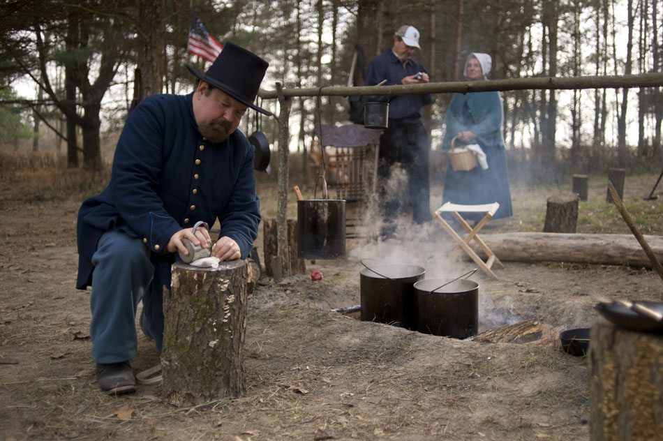 Larry Burdette crushes coffee beans to make coffee on Sunday, Nov. 20, 2010, at a Civil War-style winter encampment at Sommer Park. The re-enactors, from the Central Illinois Living Historians, created a Civil War winter encampment to show visitors how soldiers lived during the winter months in the war.