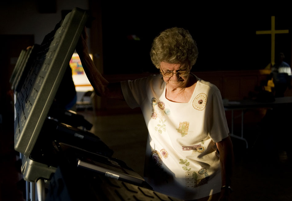 Lorraine Maxwell opens the lids of electronic voting machines on Monday, Nov.  1, 2010, at First English Lutheran Church as officials prepare for Tuesday's elections.