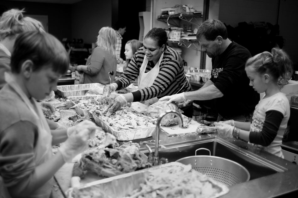 Cooks, including Tammy Echoles, middle, carve turkeys as they prepare Thanksgiving meals for the needy on Thursday, Nov. 25, 2010, at the South Side Mission.