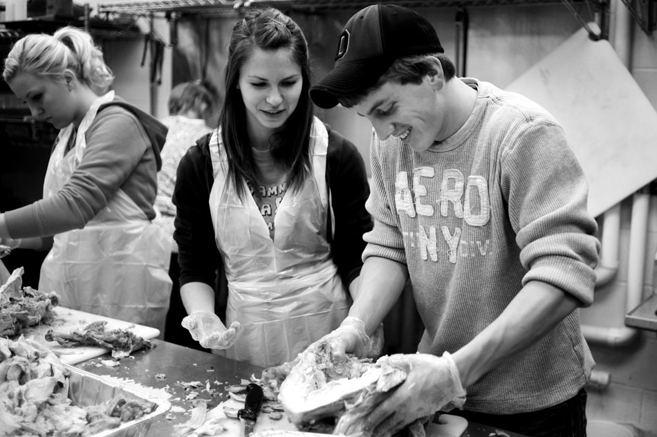 Trevor Teal, right, carves a turkey with his girlfriend, Briahna Marksity, on Thursday, Nov. 25, 2010, at the South Side Mission. Several volunteers cooked and carved turkeys to be delivered and served at the mission.