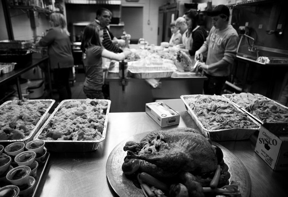 Volunteers prepare turkeys and other fixings to be distributed to the needy on Thursday, Nov. 25, 2010, at the South Side Mission.
