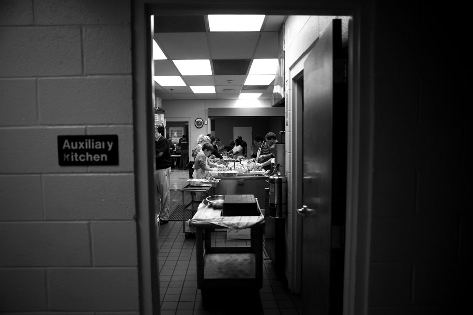 Volunteers prepare turkeys and other fixings to be distributed to the needy on Thursday, Nov. 25, 2010, at the South Side Mission.