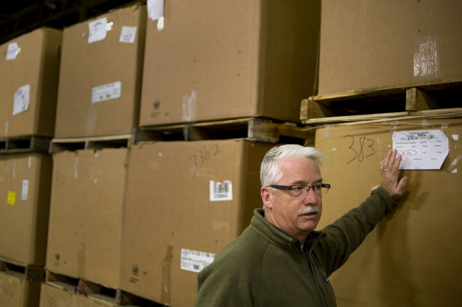 Scott Jenkins surveys stacks of boxes containing donated shoes on Monday, Nov. 15, 2010, at the Goodwill Logistics Center in East Peoria. Jenkins is in charge of the distribution center, which feeds donated items to other Goodwill locations in the region.