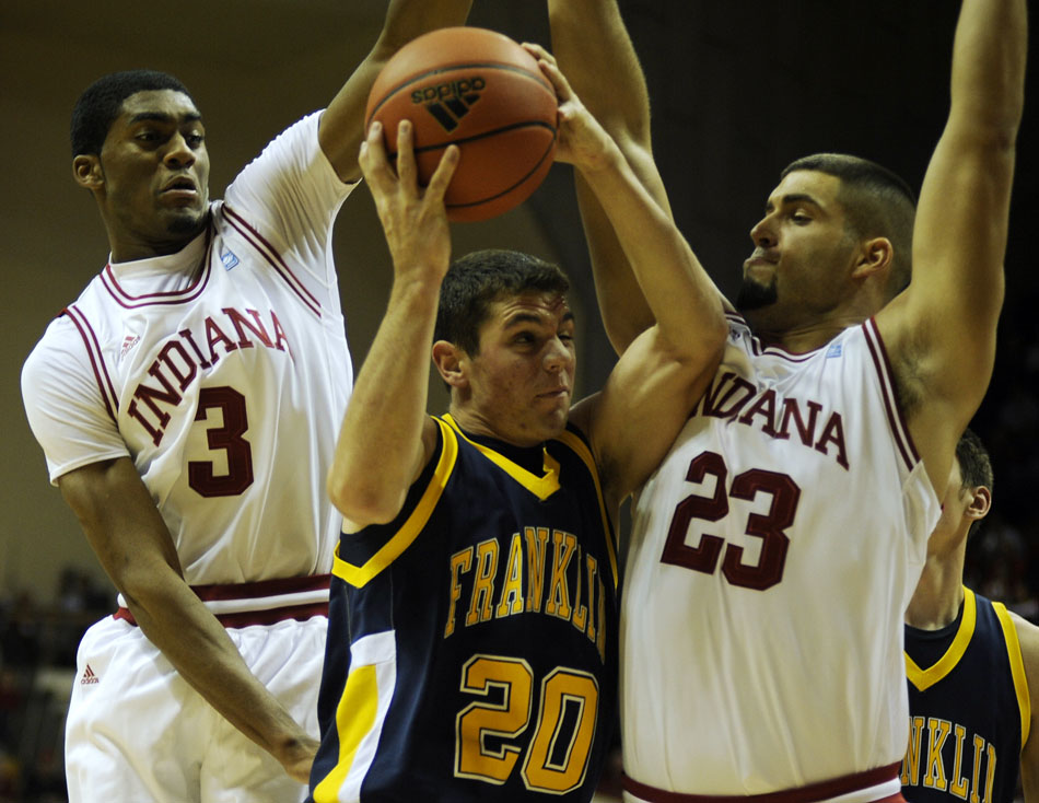 Franklin's Bailey Howard (20) tries to put up a shot over Indiana's Maurice Creek and Bobby Capobianco during a game on Wednesday, Nov. 3, 2010, at Assembly Hall in Bloomington, Ind.