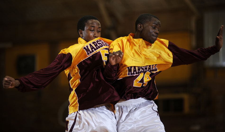Chicago Marshall's Marshon Sykes (5) chest bumps teammate Shamon Mock (24) before a game against Manual on Friday, Nov. 26, 2010, in Canton.
