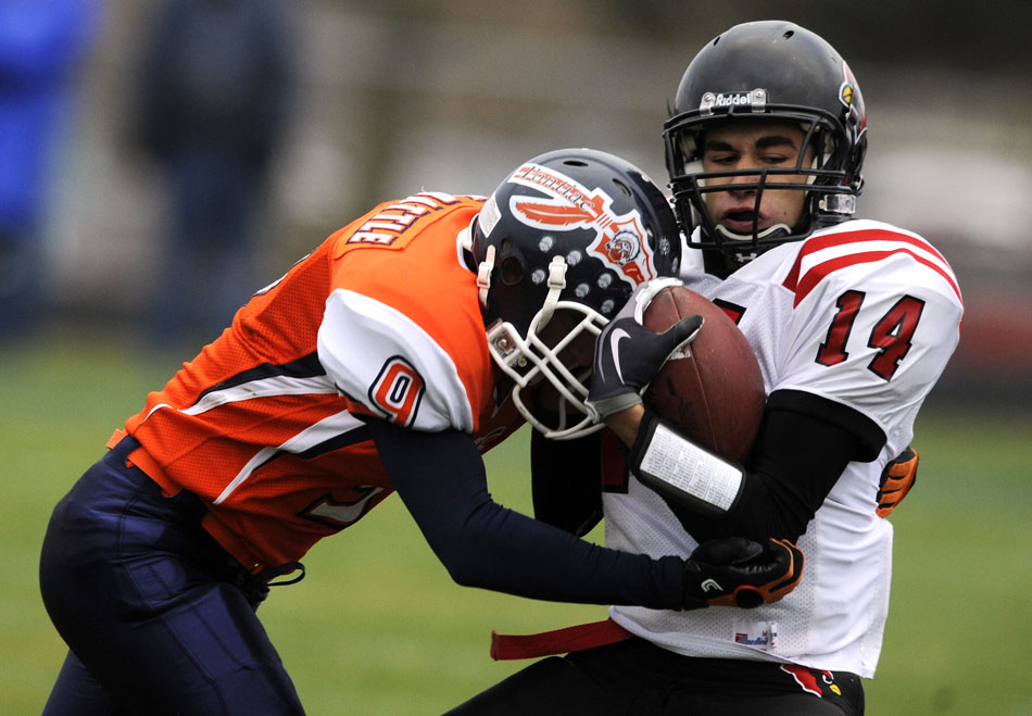 Metamora's Adam Parr (14) takes a hit from Pontiac's Kyle Battle (9) during a game on Saturday, Nov. 13, 2010, in Pontiac.