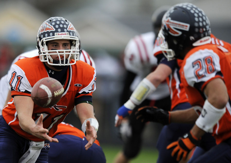 Pontiac quarterback Peter Martin pitches back to running back Chase Alford during a game on Saturday, Nov. 13, 2010, in Pontiac.