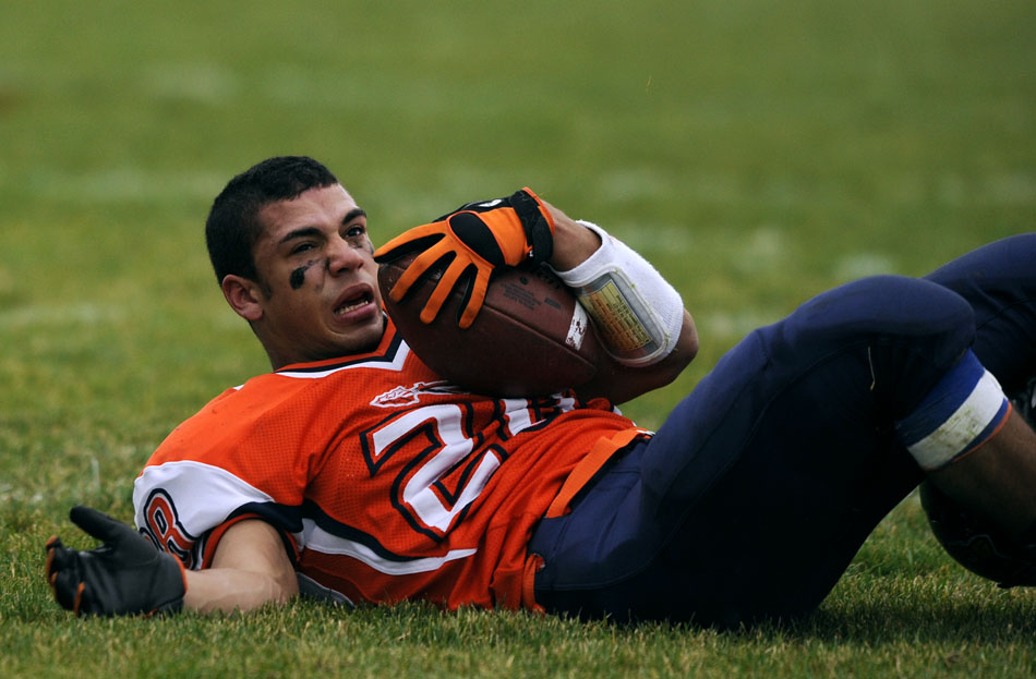 Pontiac running back Chase Alford reacts as he hits the turf after his helmet was knocked  off in a collision with a Metamora defender during a game on Saturday, Nov. 13, 2010, in Pontiac.