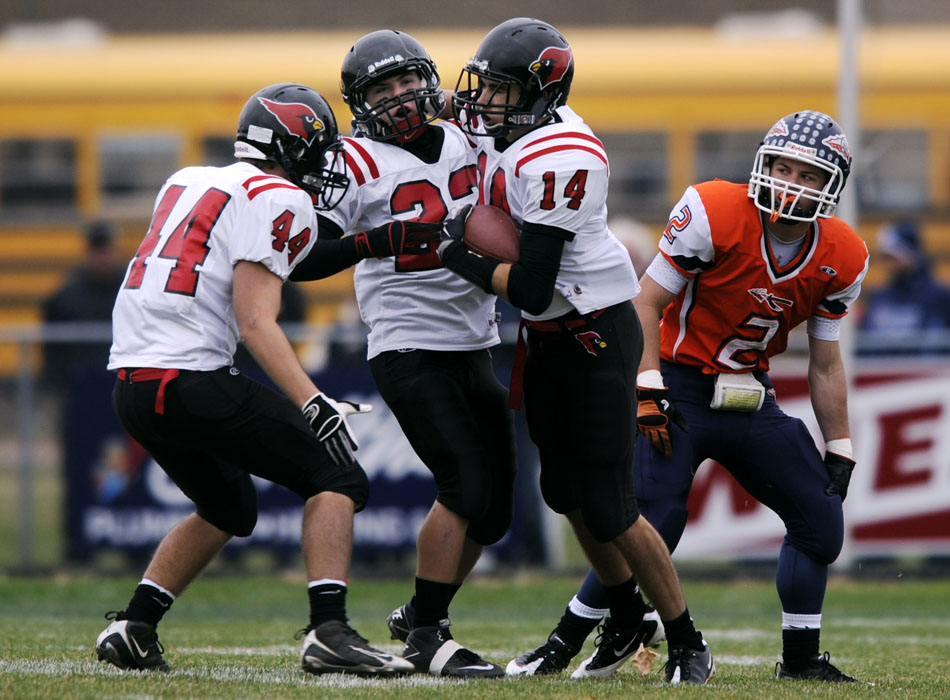 Metamora's Adam Parr (14) celebrates with teammates after intercepting a pass intended for Pontiac's Jeremiah Harrington (2) during a game on Saturday, Nov. 13, 2010, in Pontiac.