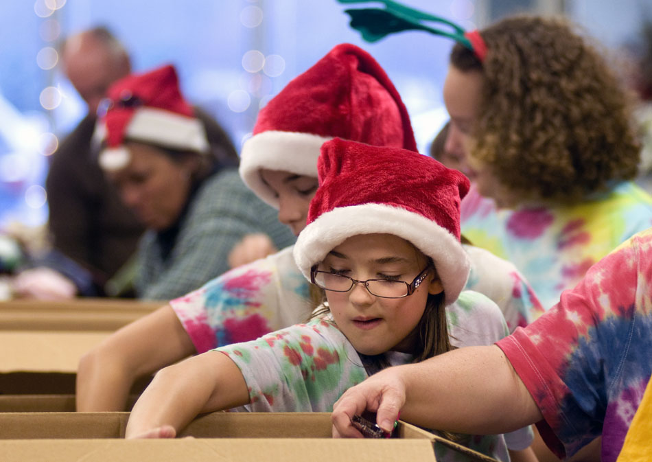 Olivia Pierpont, a Girl Scout cadet with Troop 4607 at Dunlap Middle School, reaches into a box to grab items for a stocking on Friday, Nov. 12, 2010, at the Operation Santa headquarters. Girl Scouts and other volunteers filled stockings in anticipation of the upcoming holiday season. Organizers say they hope to fill 35,000 stockings by Christmas.