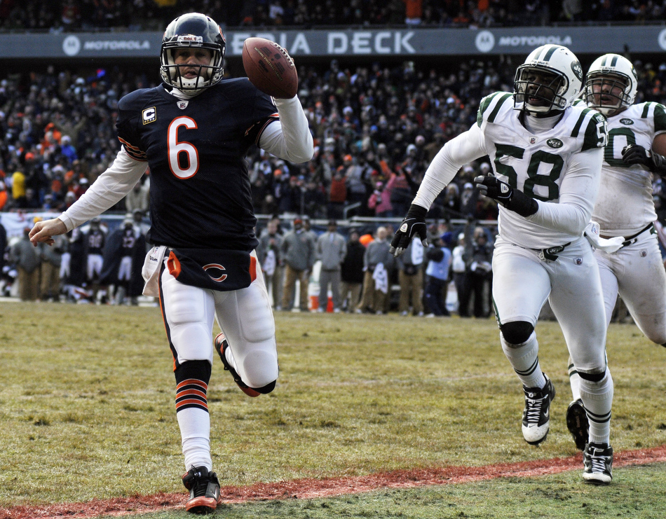 Chicago Bears quarterback Jay Cutler (6) runs the ball in for a touchdown in front of New York Jets linebacker Bryan Thomas (58) during the first half of a game on Sunday, Dec. 26, 2010, in Chicago.