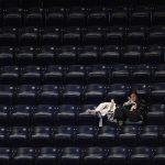 A lone fan watches the action from an empty section during a NCAA women's basketball game between Indiana and Illinois on Thursday, Jan. 7, 2010, at Assembly Hall. Bad weather and Christmas break contributed to an extremely sparse crowd at the game although the official attendance was listed at 1,350.