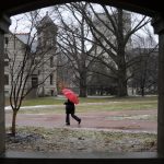 A women walks through a sleeting winter storm on Friday, Feb. 5, 2010, in the Old Crescent portion of the IU campus. Above freezing temperatures turned an anticipated snow storm into rain and sleet for the early part of the day.