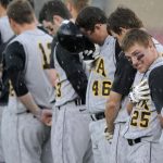 Iowa's Zach McCool (25) watches as a singer performs the National Anthem despite a sudden heavy rain shower before a game against Indiana on Friday, April 16, 2010, at Sembower Field. The game was postponed until Saturday due to rain and thunderstorms in the area.