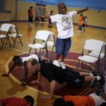 Larenz Dempz, age 7, tries to keep his balance as he stands on Brian Beavliev's back during a push up at the East Boys and Girls Club in Austin on Wednesday, June 16, 2010. Area youngsters participated in a Police Activities League basketball camp at the gymnasium.