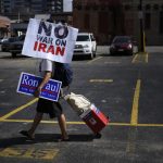 A Ron Paul supporter makes his way along Third Street with an anti-war sign on Saturday, July 24, 2010.